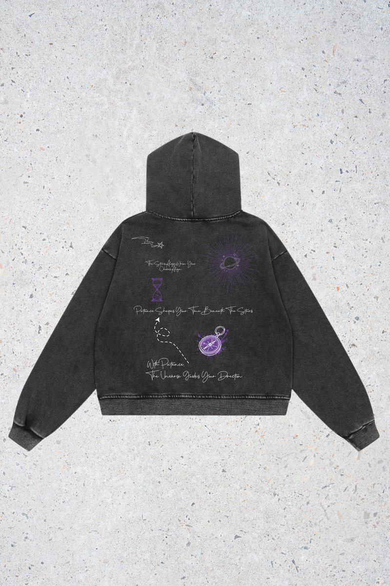 Black hoodie with purple graphics on a textured gray background