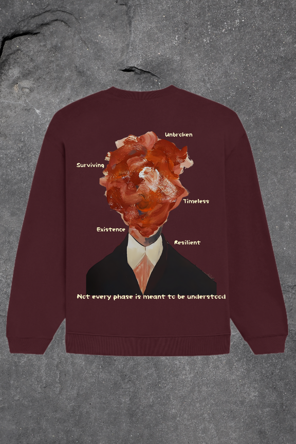 Maroon sweatshirt with graphic design and text on a textured gray background