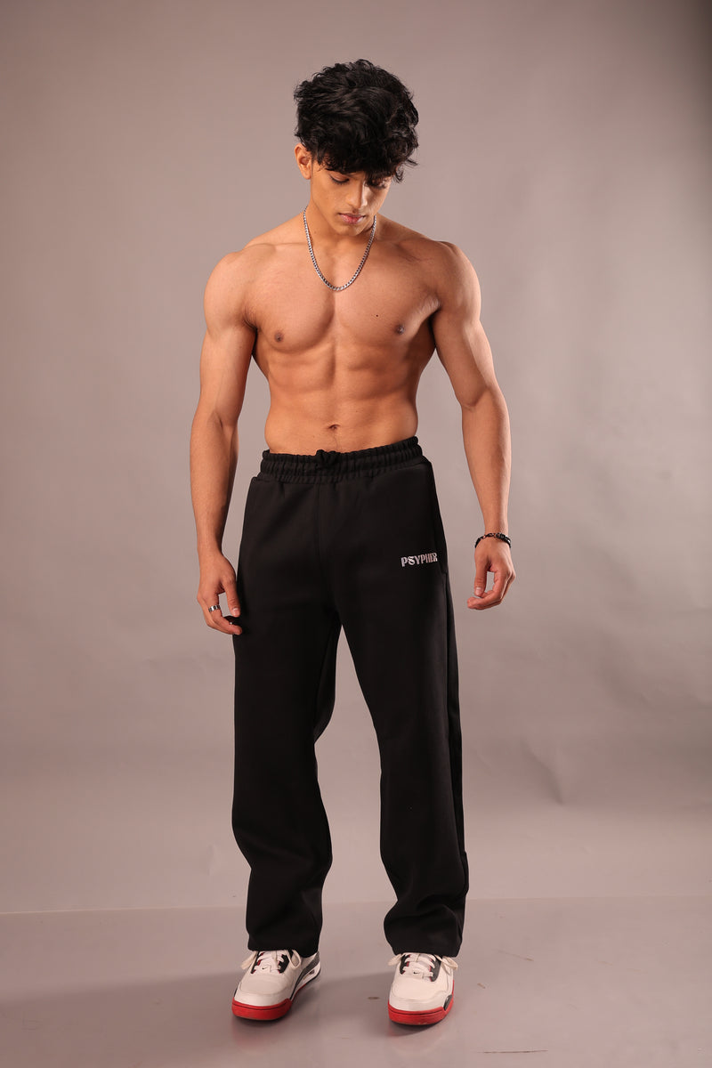 Model wearing black wide leg streetwear joggers for unisex by Psypher India