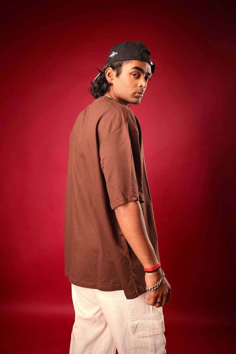 Streetwear model in solid brown oversized tee from Psypher
