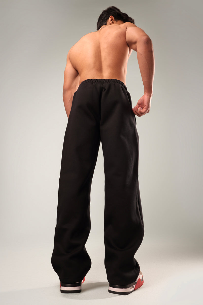 Back view of Psypher black wide leg joggers for Indian streetwear look